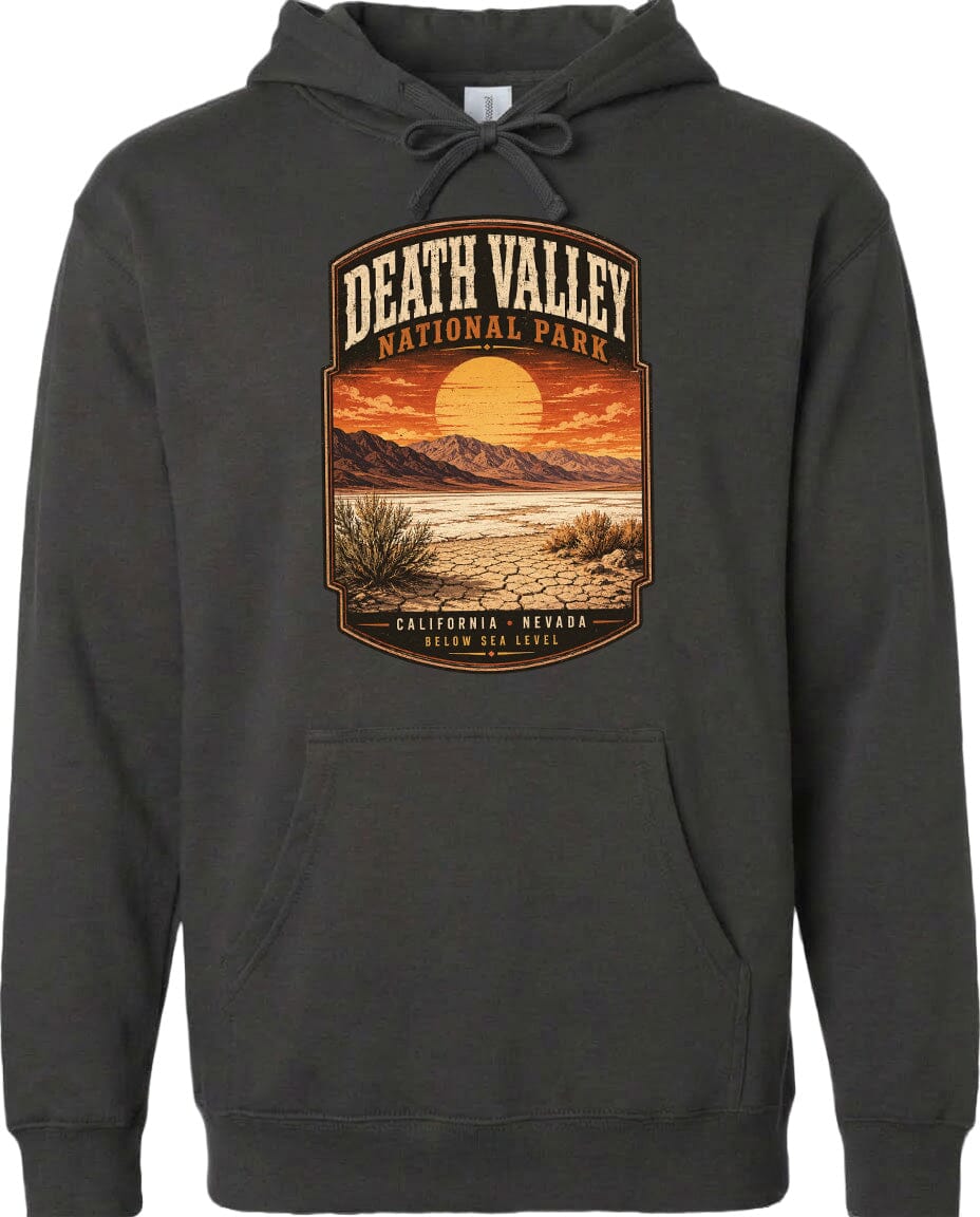 A hoodie with a graphic design depicting a desert landscape with mountains, a sunset, and a cactus plant.