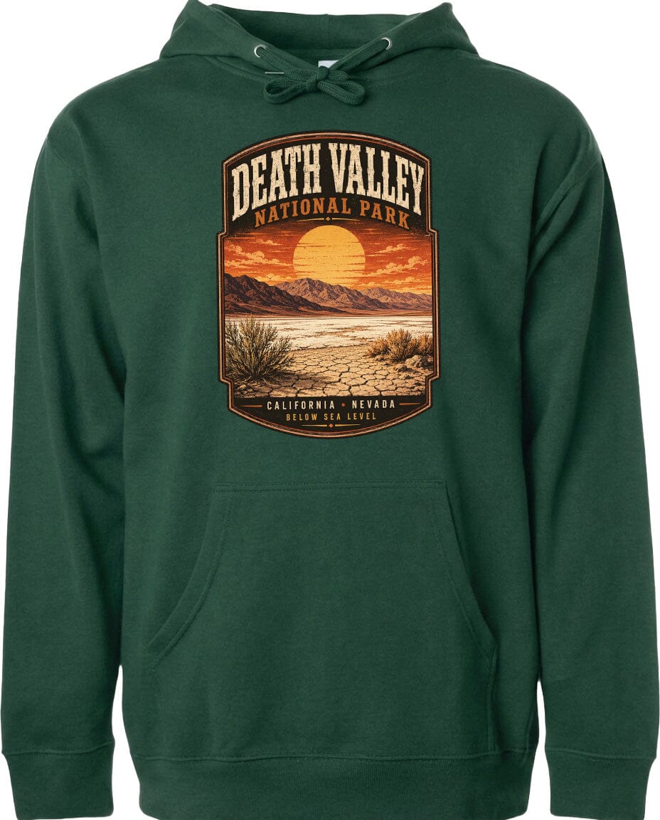 A green hoodie with a graphic design depicting a desert landscape with mountains, a sunset, and a cactus plant.