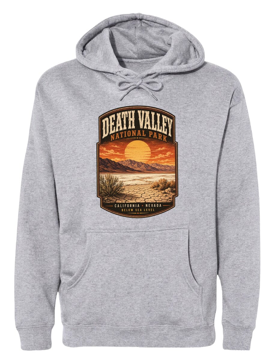 A gray hoodie with a graphic design depicting Death Valley National Park, including a sunset landscape and mountains.