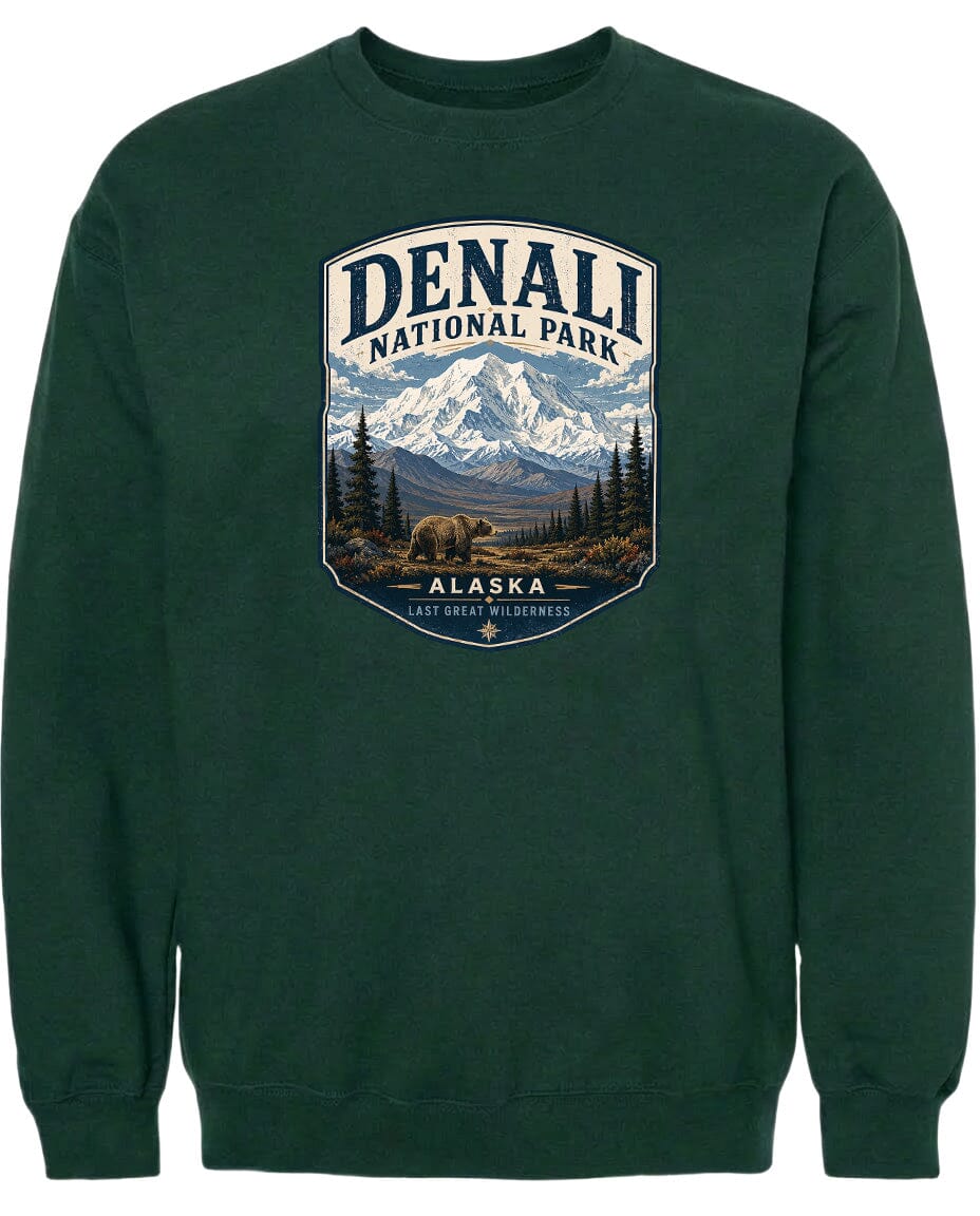 A green sweatshirt with a graphic design depicting Denali National Park in Alaska, featuring a mountain landscape with a bear in the foreground.