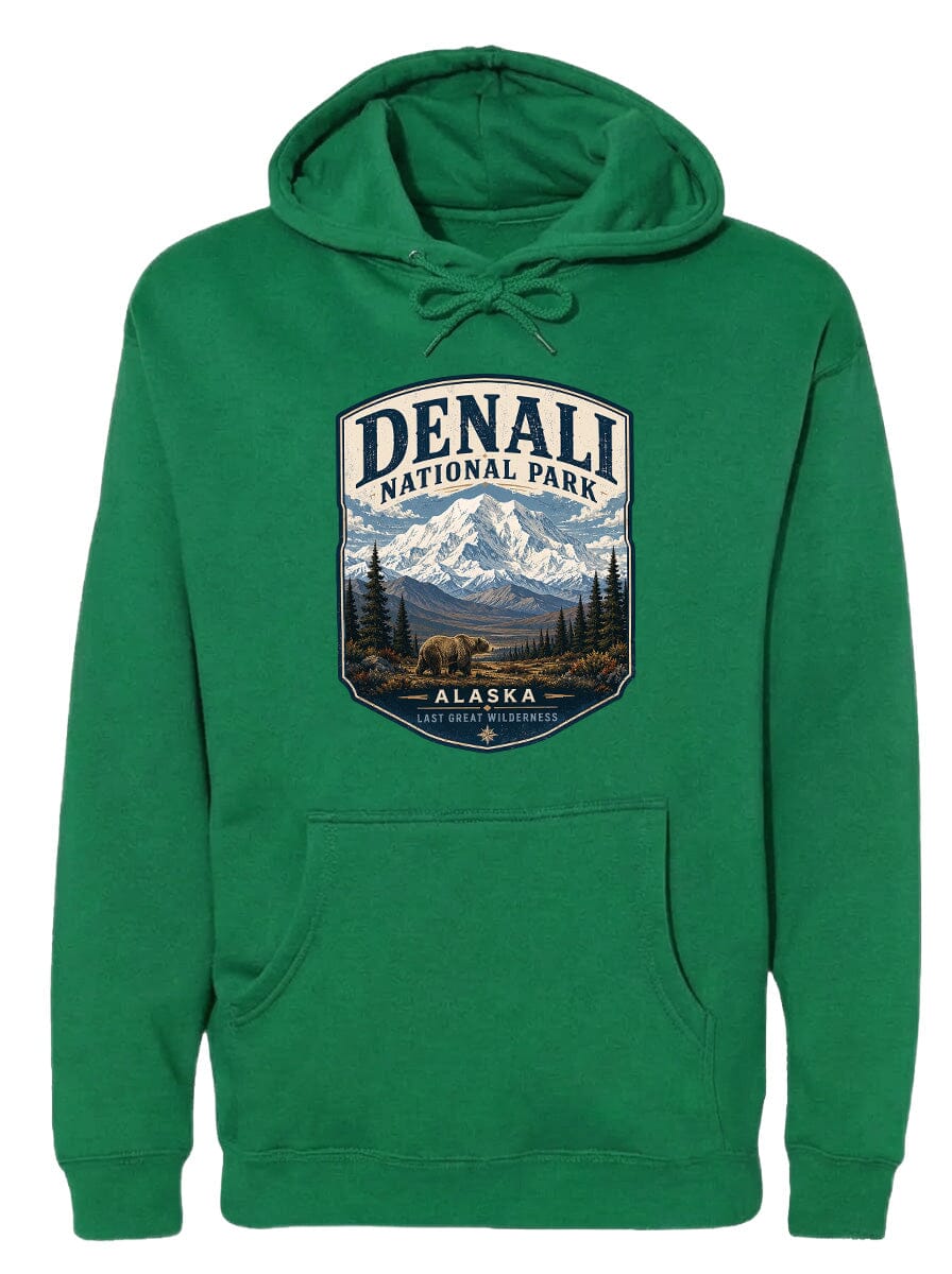 A green hoodie with a graphic design depicting Denali National Park and Alaska, featuring a mountain landscape with a bear.