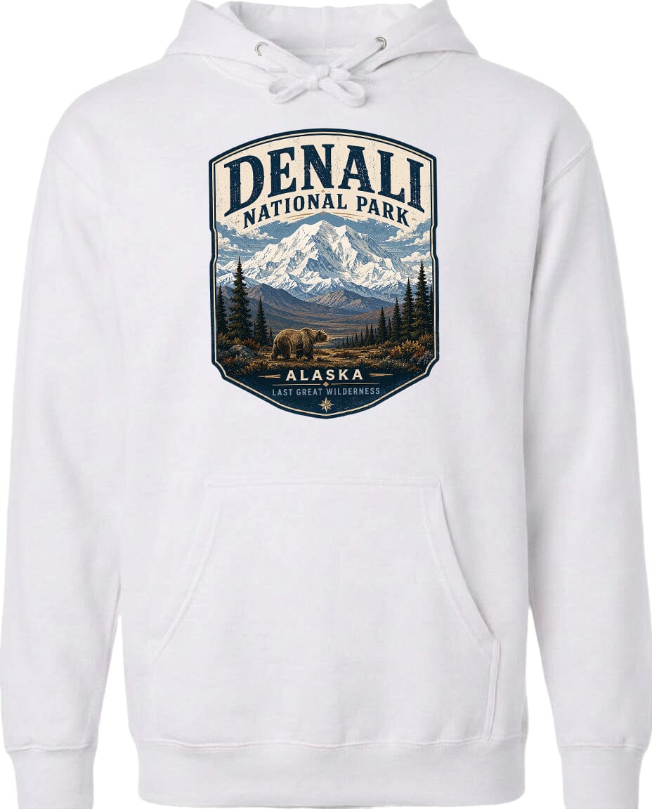 A white hoodie with a graphic design depicting Denali National Park in Alaska, featuring a mountain landscape with a bear in the foreground.