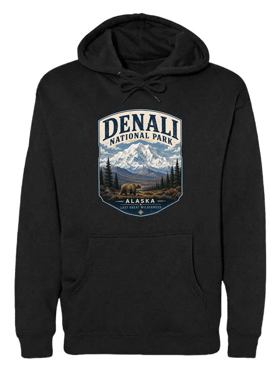 A black hoodie with a graphic design depicting Denali National Park in Alaska, featuring a mountain landscape with a bear in the foreground.