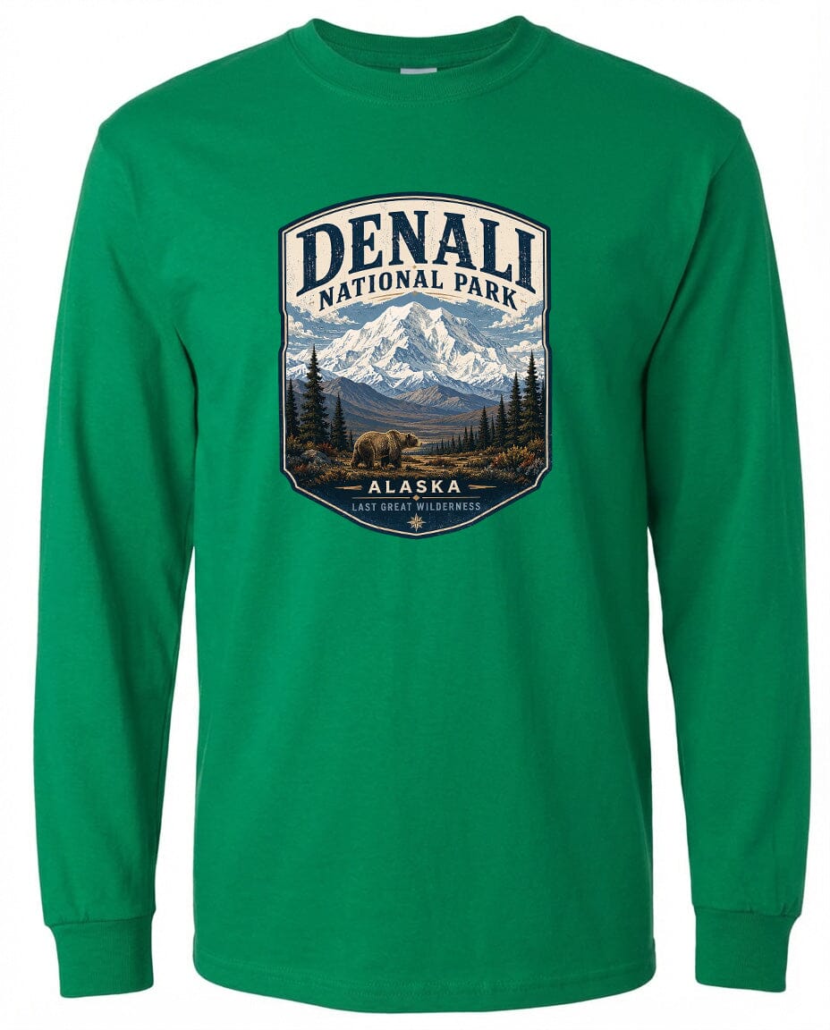A green long-sleeved t-shirt with a graphic design depicting Denali National Park in Alaska, featuring a mountain landscape with a bear in the foreground.