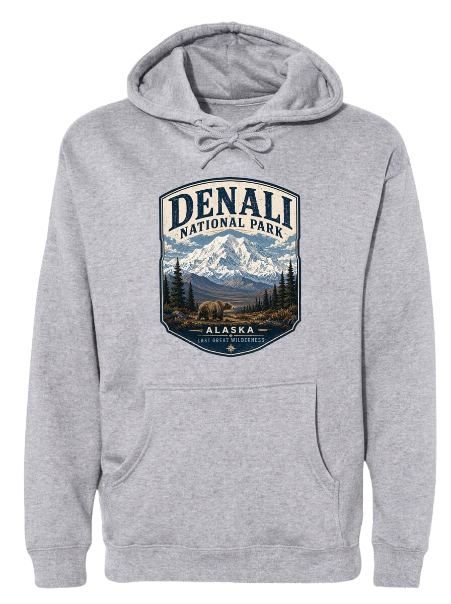 A gray hoodie with a graphic design featuring a mountain landscape and a bear, along with the text "DENALI NATIONAL PARK ALASKA LAST GREAT WILDERNESS".
