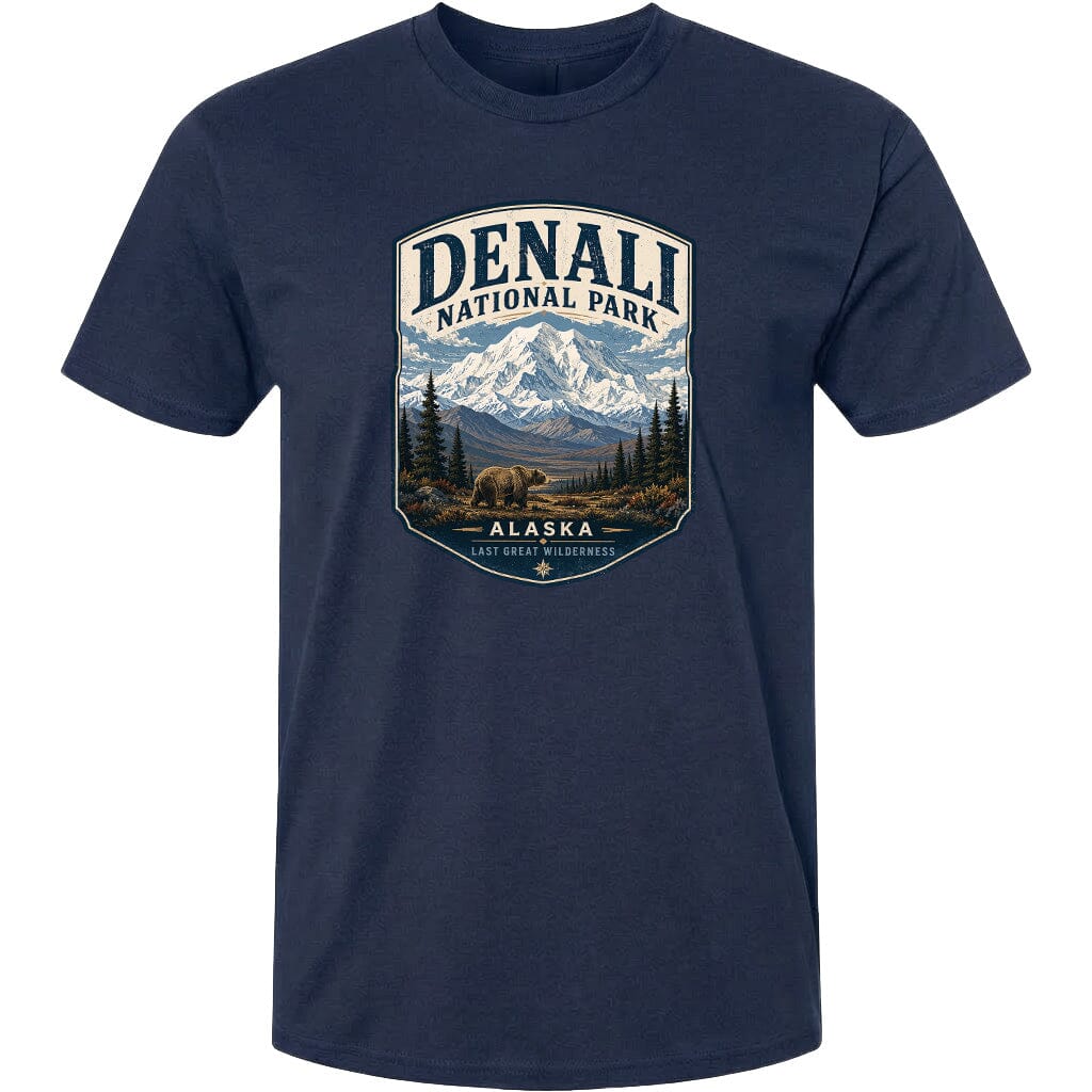 A navy blue t-shirt with a graphic design depicting a mountain landscape with a bear in the foreground, surrounded by pine trees and mountains.