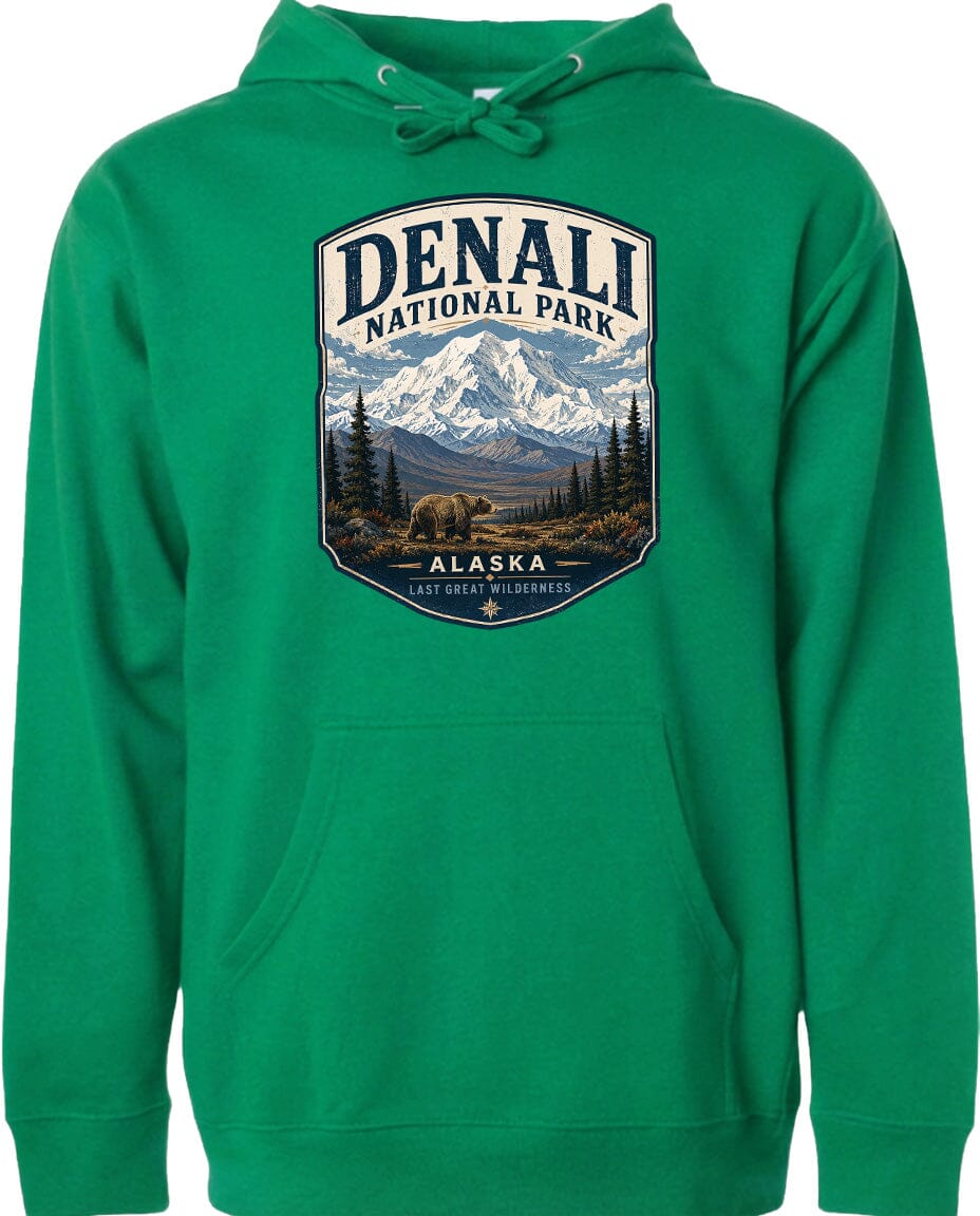 A green hoodie with a graphic design depicting Denali National Park in Alaska, featuring a mountain landscape with a bear in the foreground.