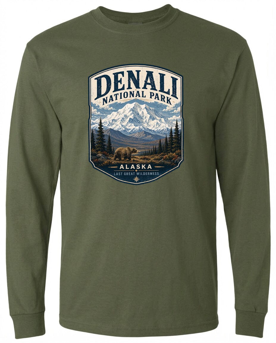 A green long-sleeved t-shirt with a graphic design depicting a bear in the foreground and a mountain range in the background, along with the text "DENALI NATIONAL PARK ALASKA LAST GREAT PLEASANCE".