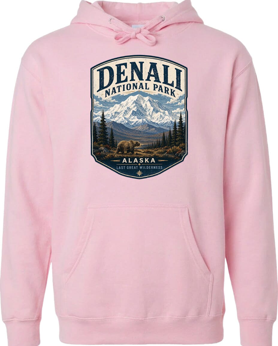 A pink hoodie with a graphic design depicting a mountain landscape and a bear, representing Denali National Park in Alaska.