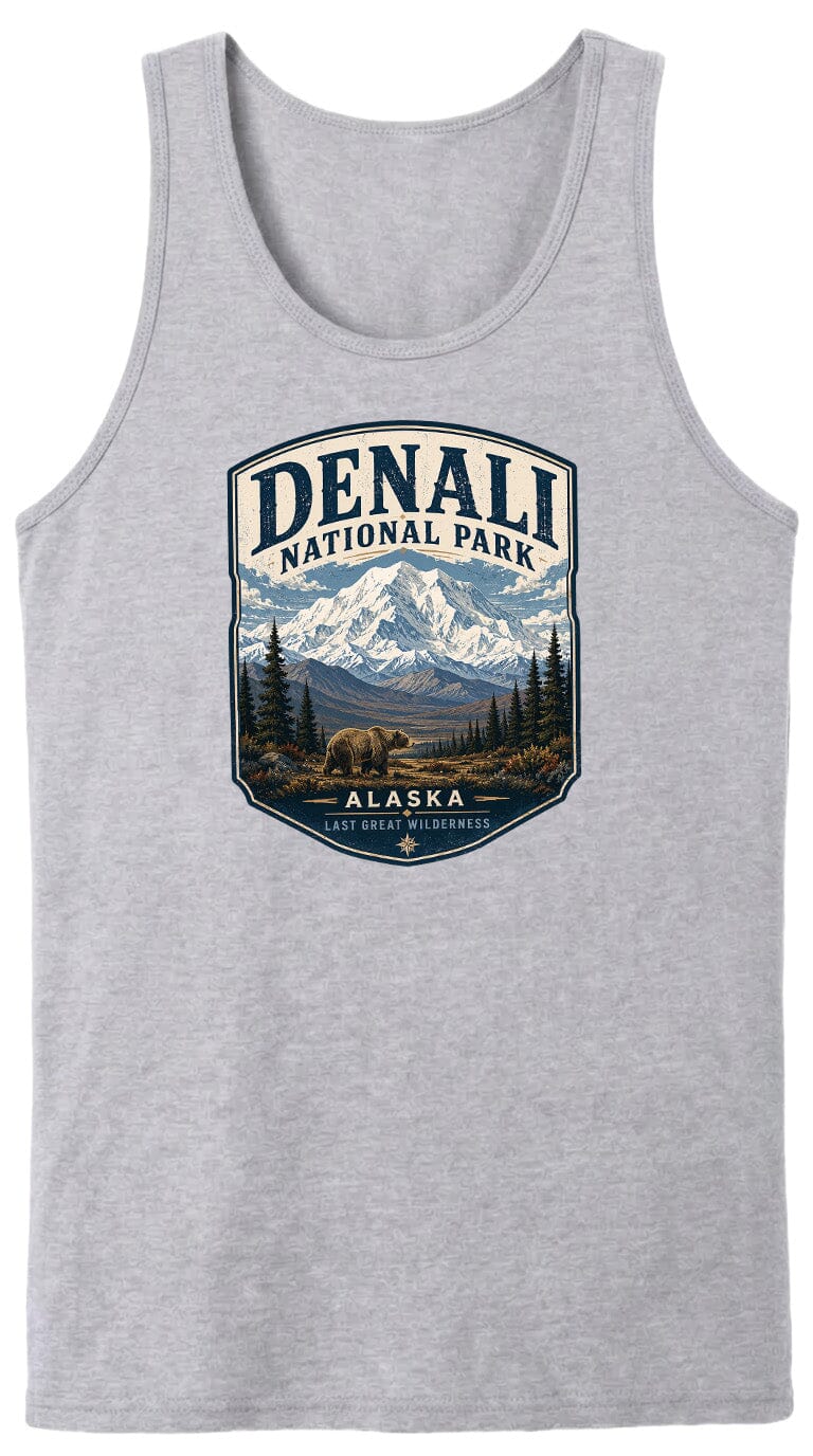 A gray tank top with a graphic design depicting a mountain landscape with a bear in the foreground, surrounded by pine trees and mountains.