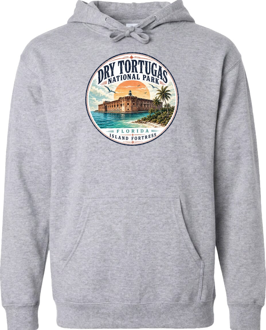 A gray hoodie with a circular design featuring a tropical island and a building, surrounded by text that says "Dry Tortugas National Park, Florida Island Fortresses".