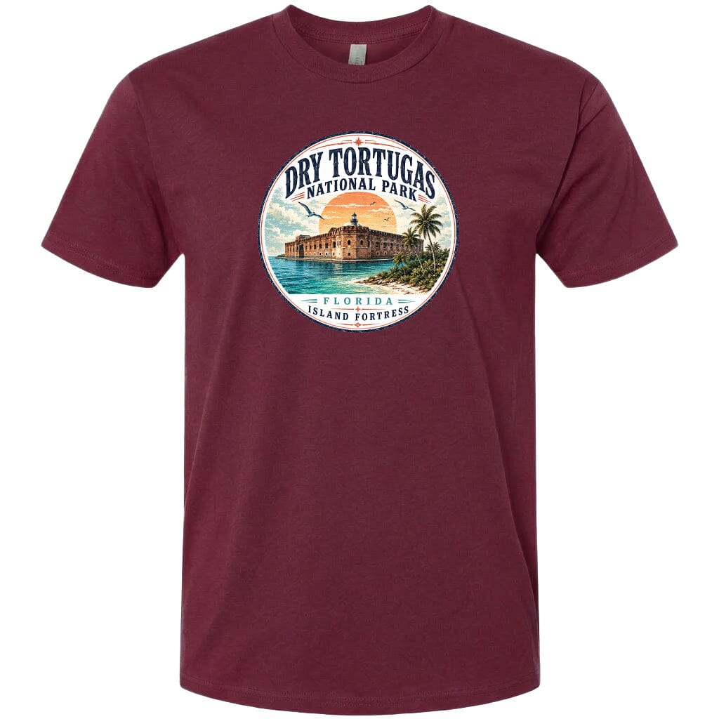 A t-shirt with a circular design featuring a beach scene and a building, likely representing Dry Tortugas National Park in Florida.