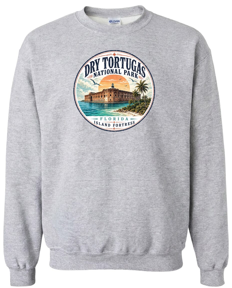 A gray sweatshirt with a circular graphic design featuring a building and palm trees, along with the text "Dry Tortugas National Park, Florida Island Fortress".