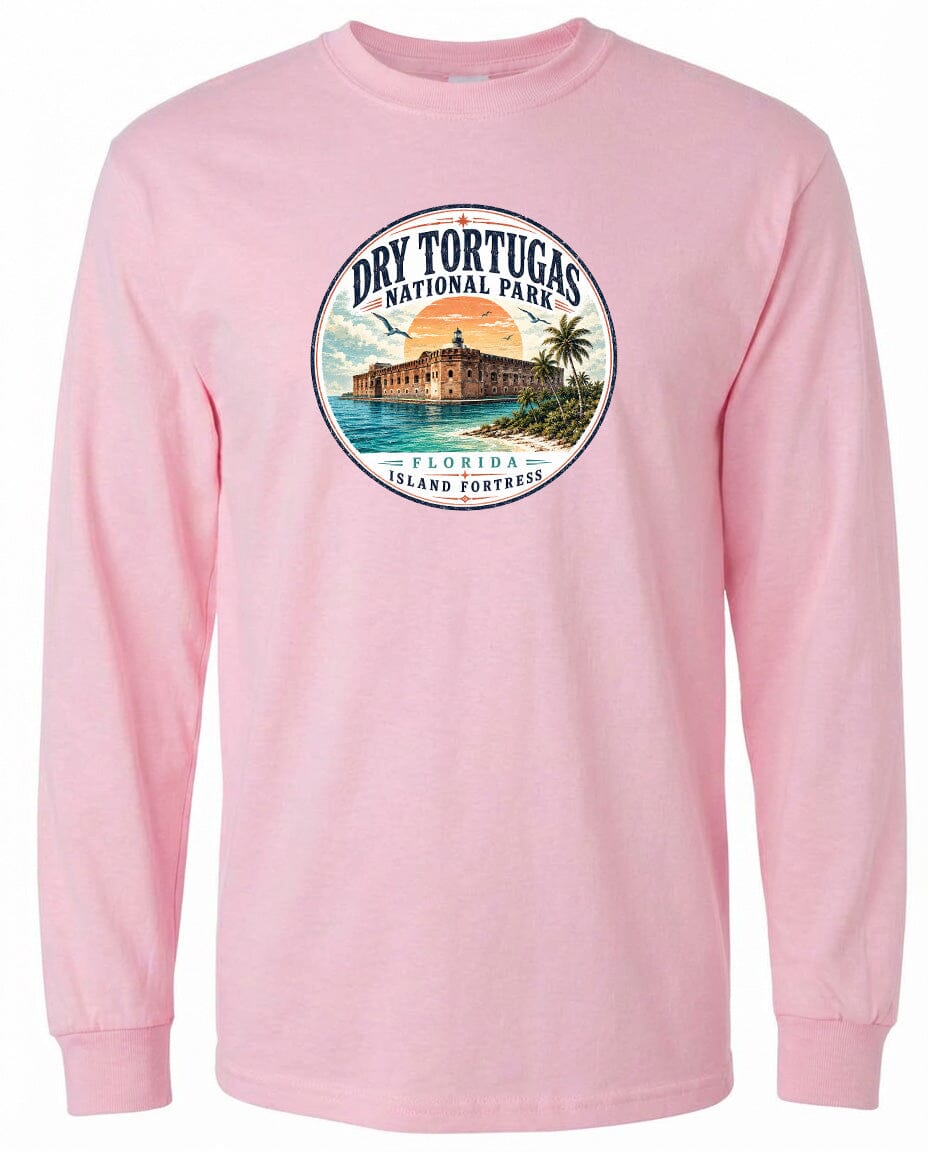 A pink long-sleeved t-shirt with a circular graphic design featuring a beach scene and a building, likely representing Dry Tortugas National Park in Florida.