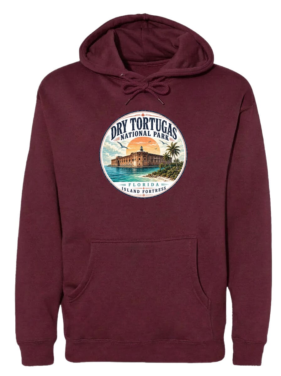 A burgundy hoodie with a circular design featuring a tropical island with a castle, palm trees, and a sunset.