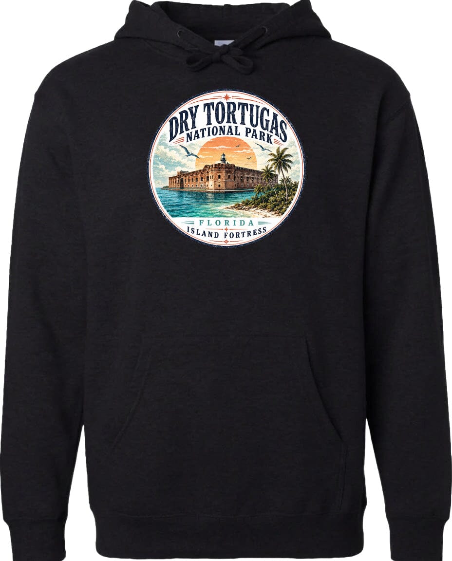 A black hoodie with a circular design featuring a tropical island and a building, surrounded by text that says "Dry Tortugas National Park, Florida Island Fortress".