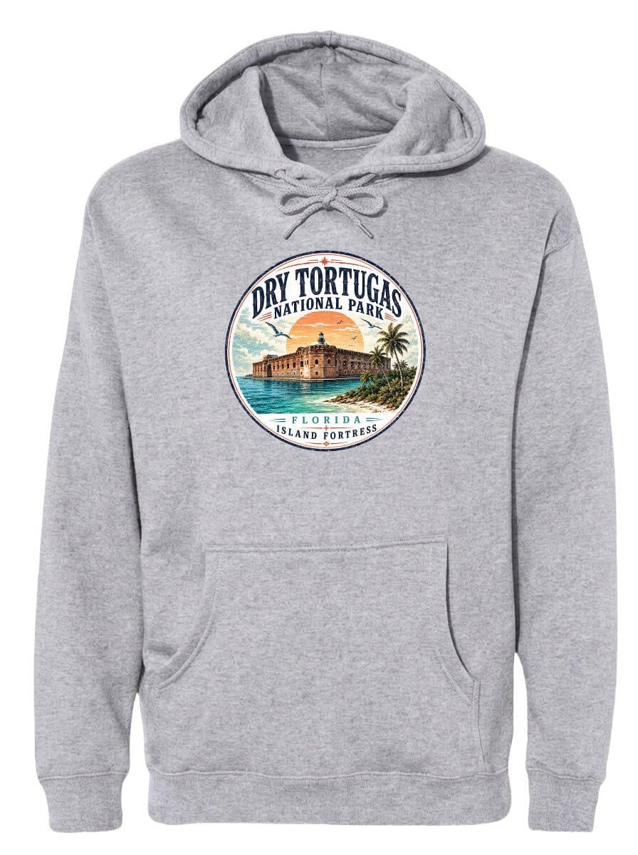 A gray hoodie with a circular design featuring a tropical island with a castle, palm trees, and a sunset.