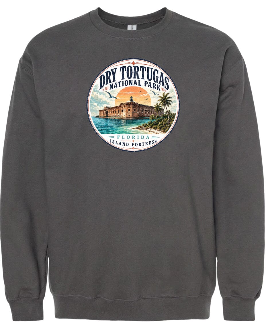 A gray sweatshirt with a circular graphic design featuring a building and palm trees, along with the text "Dry Tortugas National Park, Florida Island Fortresses".