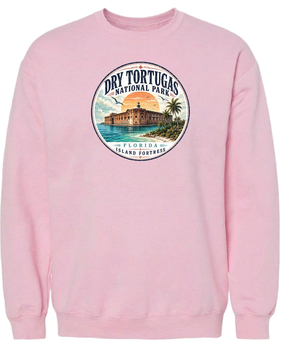 A pink sweatshirt with a circular graphic design featuring a building, palm trees, and a sunset over the ocean.