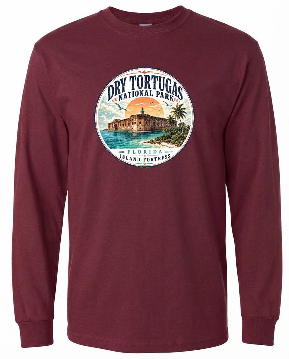 A circular graphic on a burgundy long-sleeve shirt, depicting a tropical island with a building and palm trees.