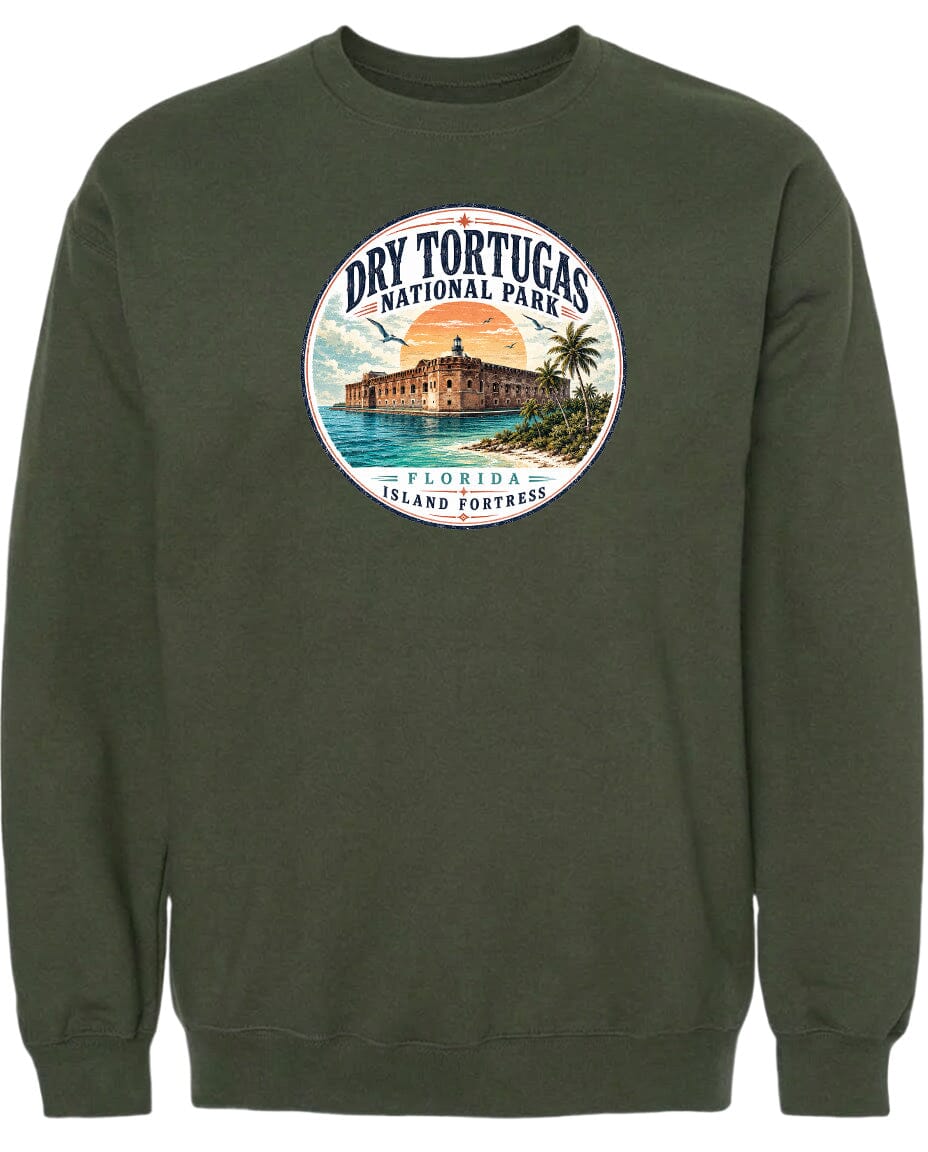 A circular graphic on a dark green sweatshirt depicting a tropical island with a building and palm trees, surrounded by a sunset and ocean.