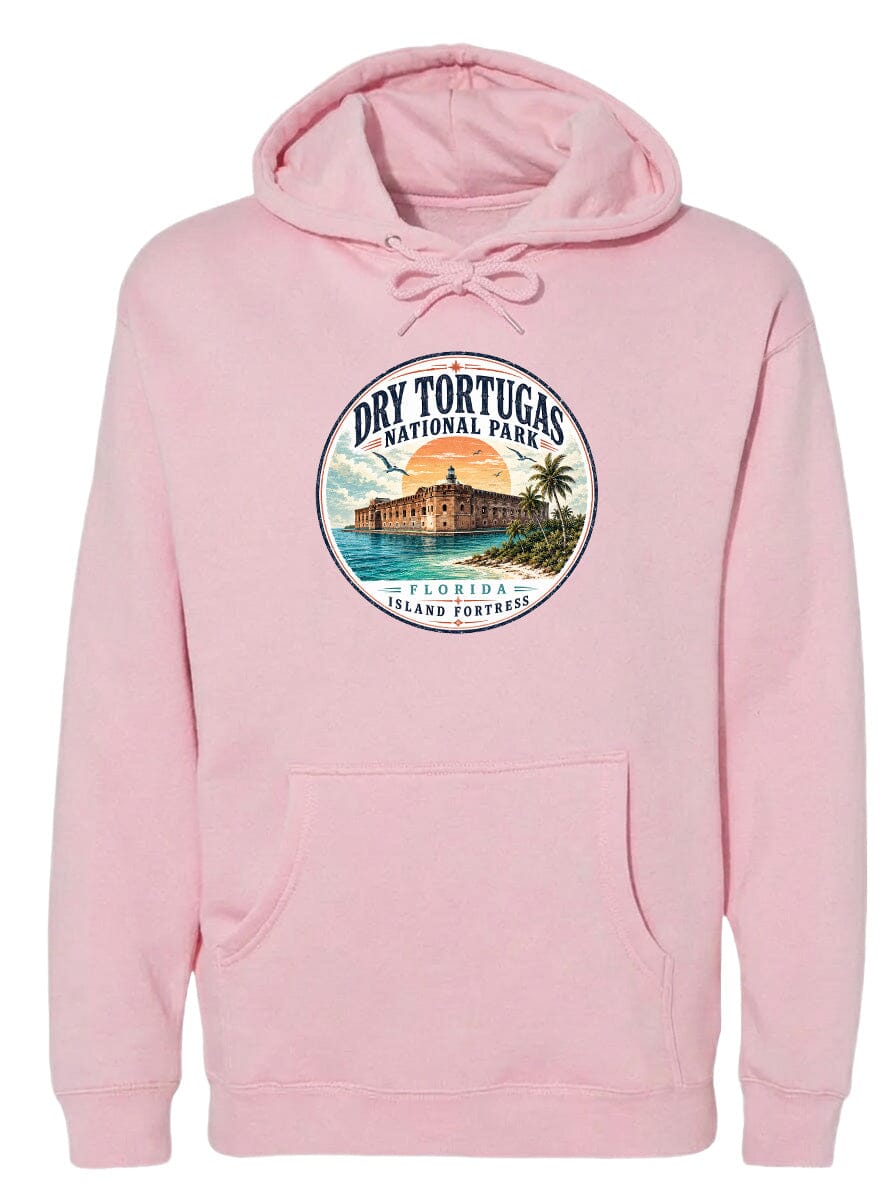 A pink hoodie with a circular design featuring a tropical island with a castle, palm trees, and a sunset.
