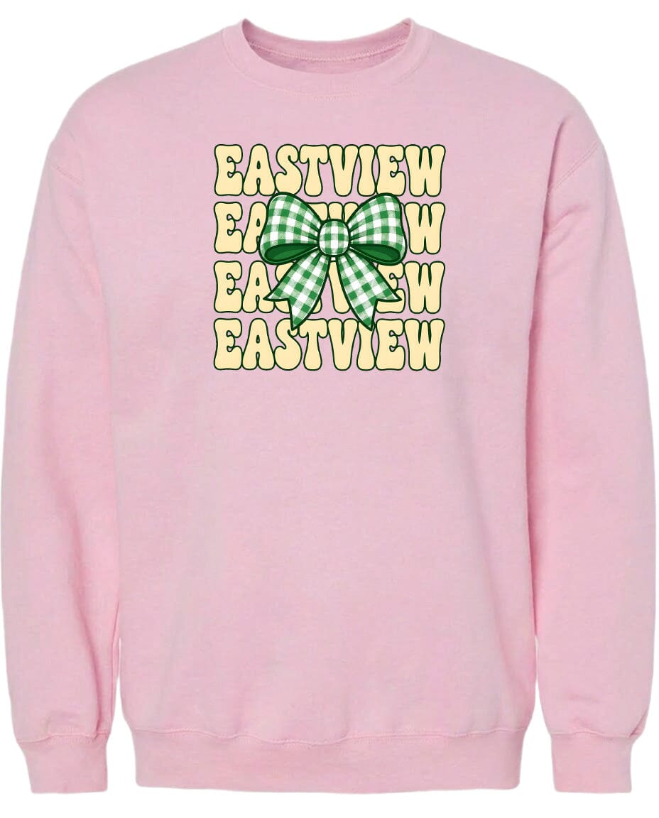 A pink sweatshirt with a graphic design featuring a green and white checkered bow on the front.