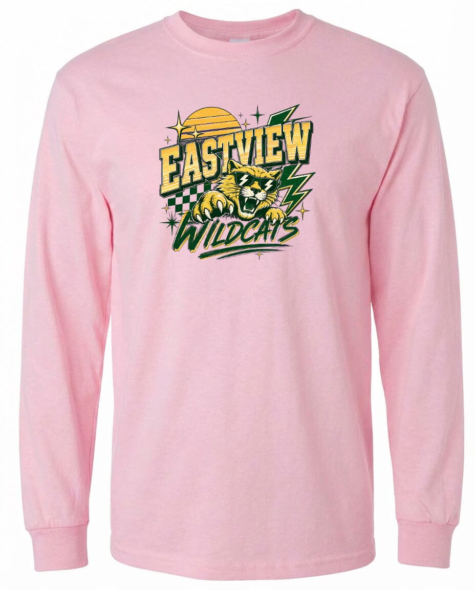 A pink long-sleeved t-shirt with a graphic design featuring a yellow and green checkered pattern, a yellow sun, and a graphic of a wildcat.