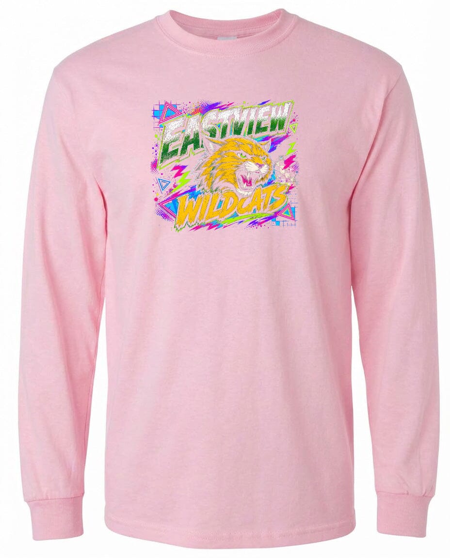 A pink long-sleeved t-shirt with a graphic design featuring a yellow and orange tiger or lion-like creature with a fierce expression, surrounded by colorful, abstract shapes and text.