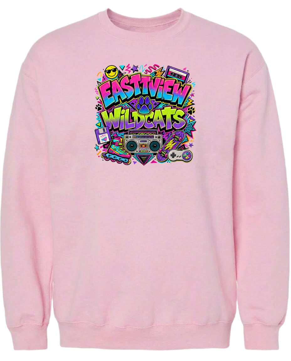 A pink sweatshirt with a colorful graphic design featuring the text "EASTVIEW WILDCATS" surrounded by various icons and symbols, such as a boombox, skateboard, and other retro-style elements.