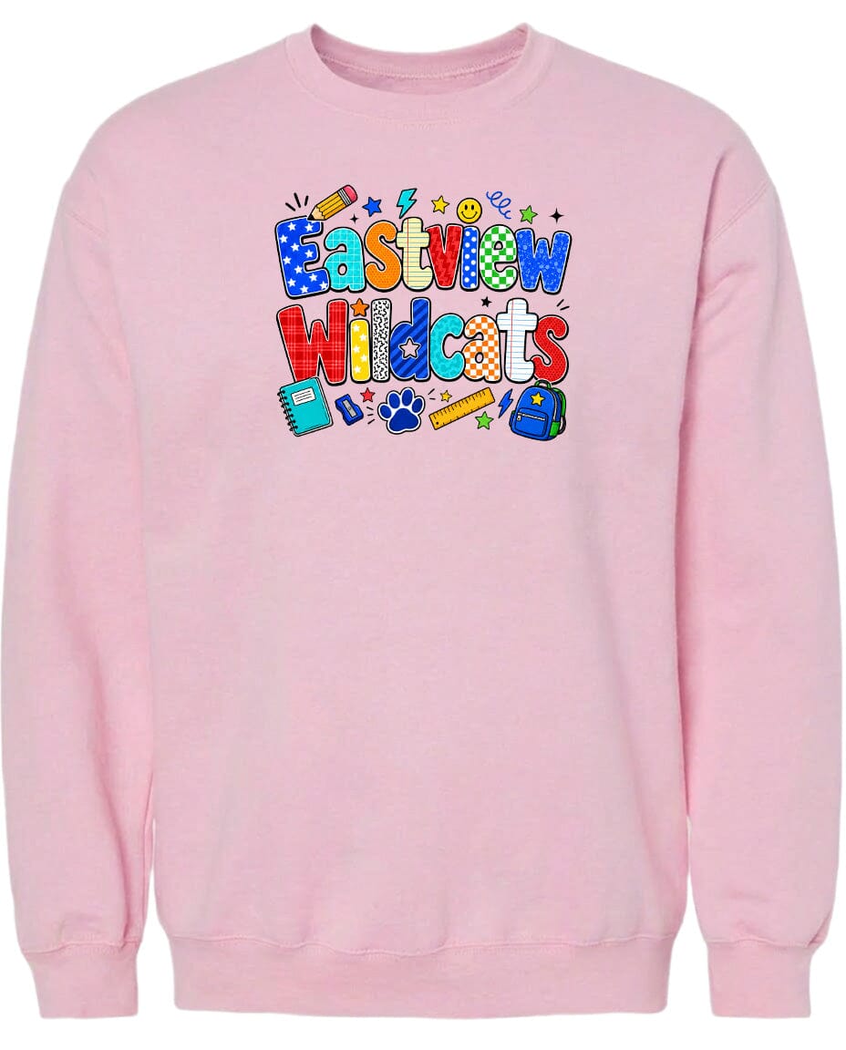 A pink sweatshirt with a colorful graphic design featuring the text "Eastview Wildcats" and various school-related icons such as a pencil, backpack, and calculator.