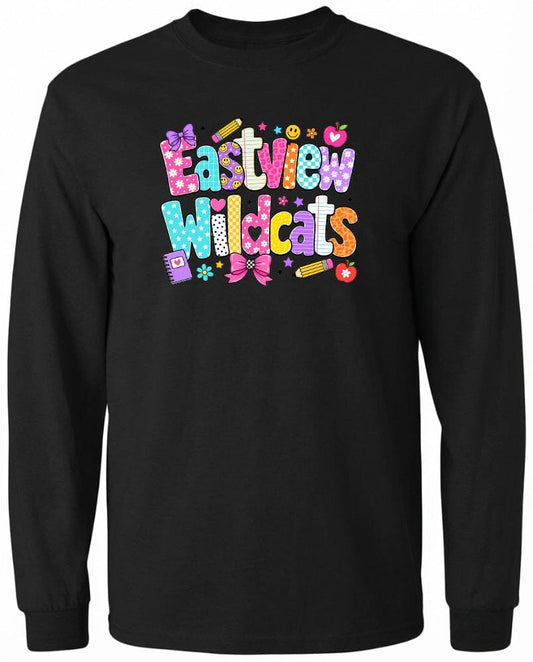 A black long-sleeved shirt with a colorful, playful design featuring the text "Eastview Wildcats" and various decorative elements such as flowers, hearts, and pencils.