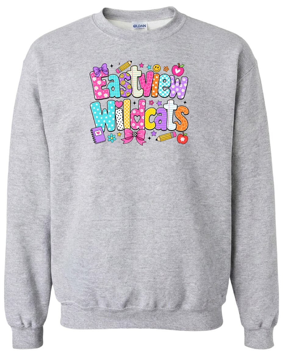 A gray sweatshirt with a colorful graphic design featuring the text "Eastview Wildcats" and various school-related icons such as pencils, apples, and books.