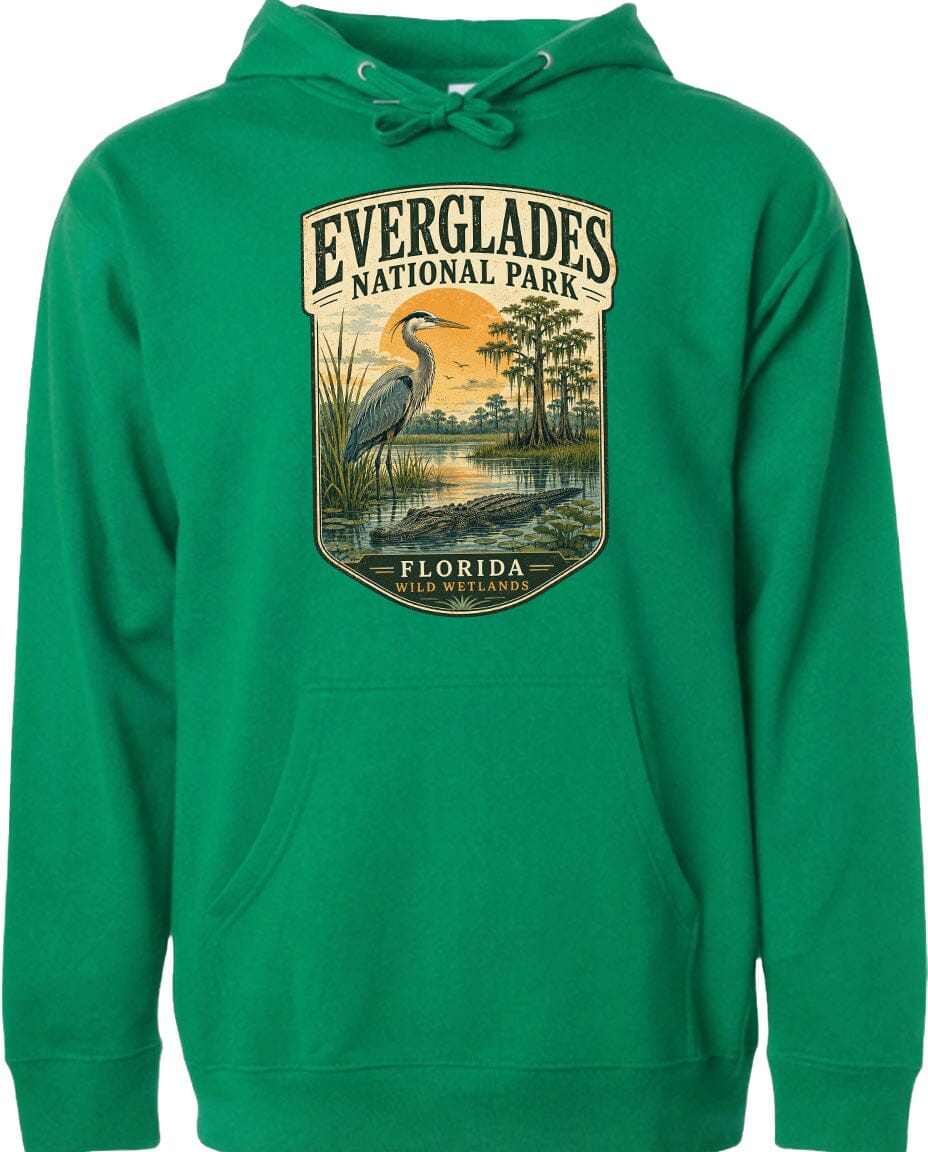 A green hoodie with a graphic design depicting a bird standing in a marshy area with trees and a sunset in the background.