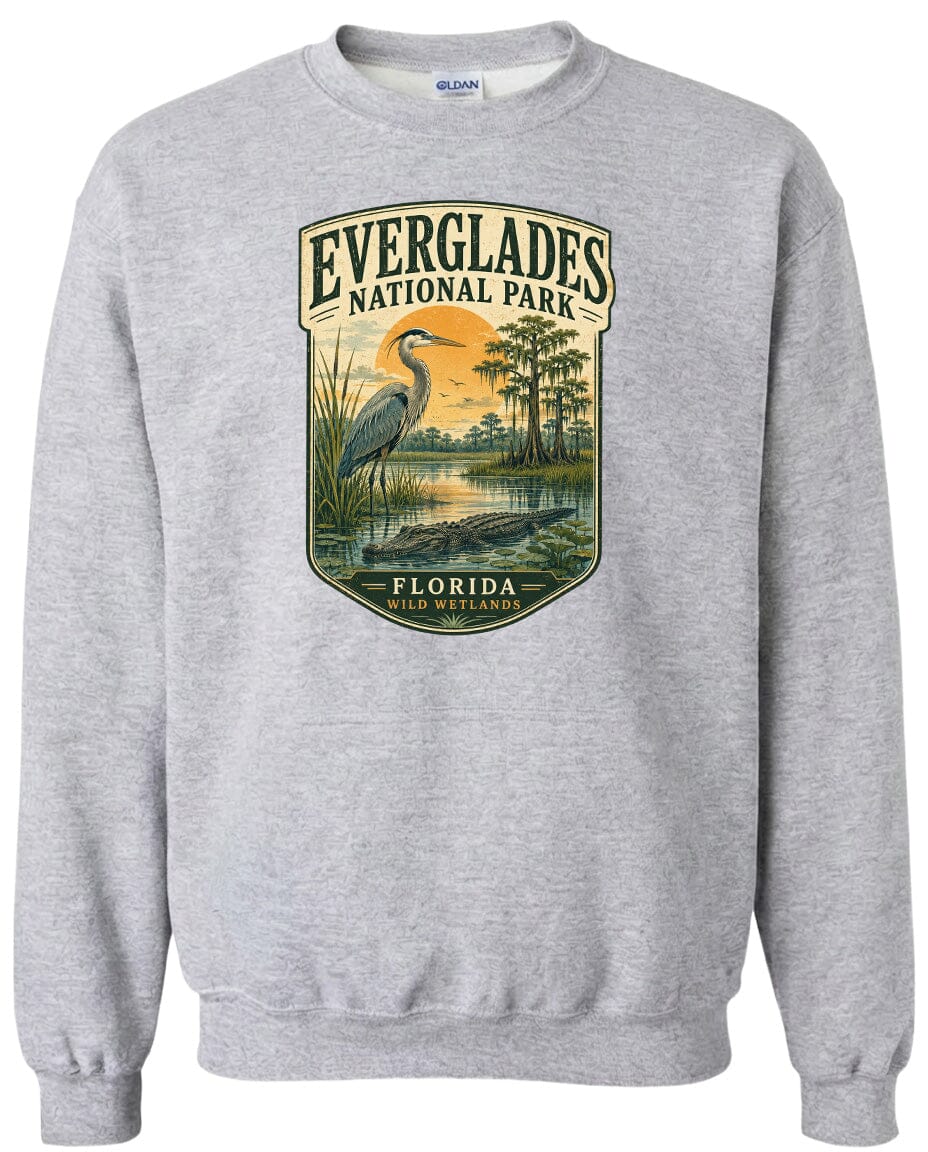 A gray sweatshirt with a graphic design depicting Everglades National Park, Florida, featuring a heron and a sunset landscape.