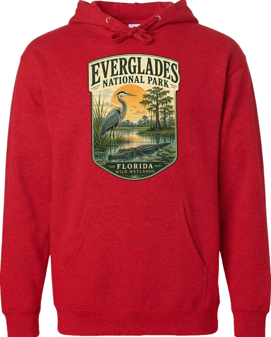 A red hoodie with a graphic design depicting a bird standing in a marshy area with trees and a sunset in the background.