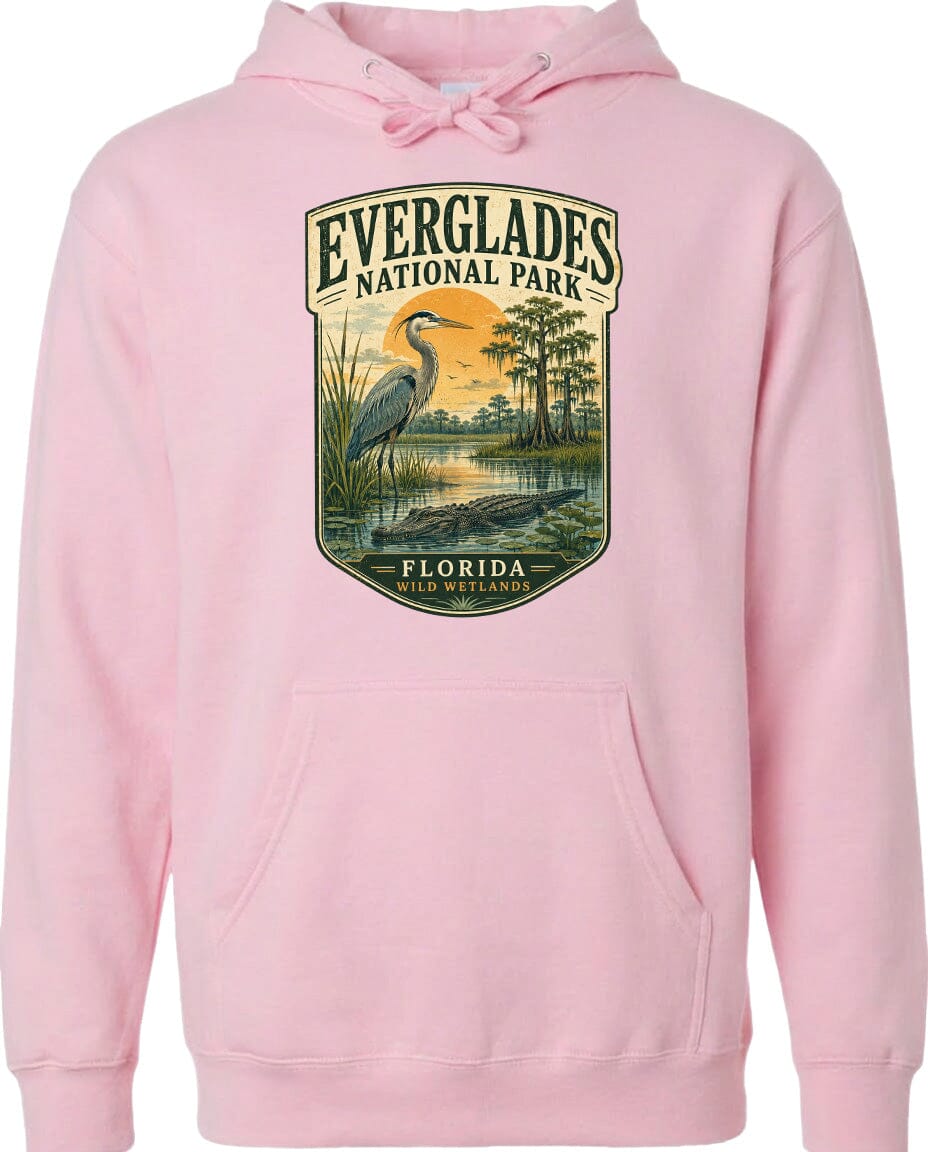 A pink hoodie with a graphic design depicting a heron and a sunset over Everglades National Park, Florida.