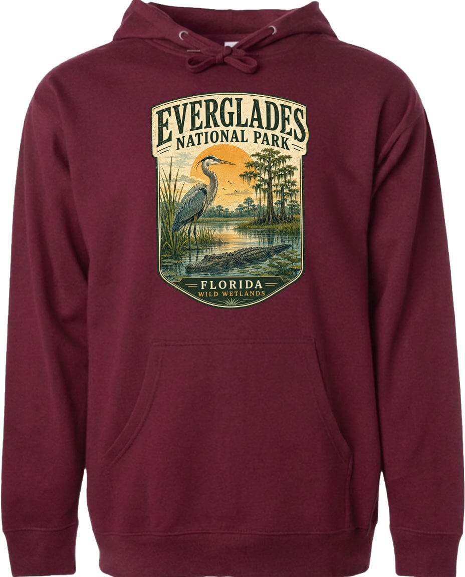 A maroon hoodie with a graphic design depicting a heron and a landscape with trees and water, along with the text "EVERGLADES NATIONAL PARK FLORIDA".