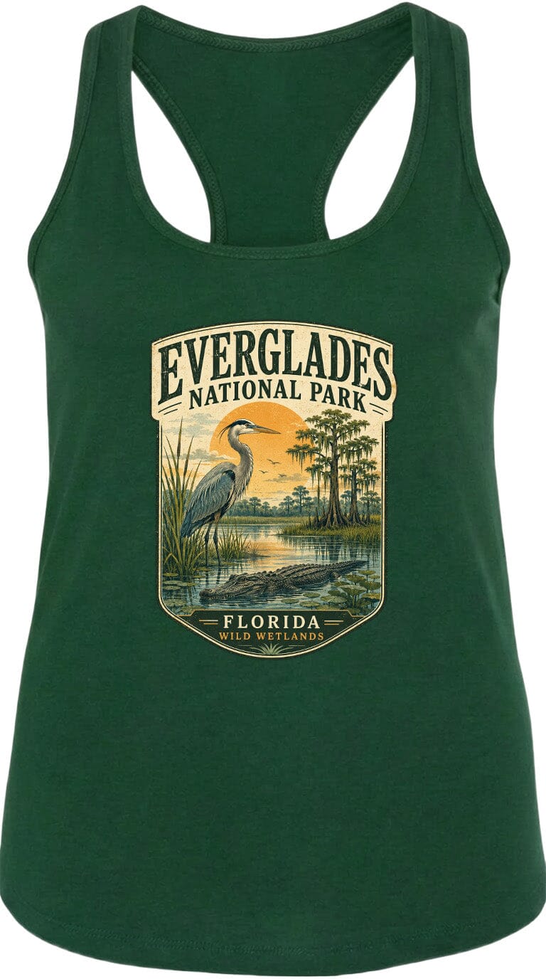 A green tank top with a graphic design depicting a bird, a sunset, and a body of water, along with the text "EVERGLADES NATIONAL PARK FLORIDA WILDER".