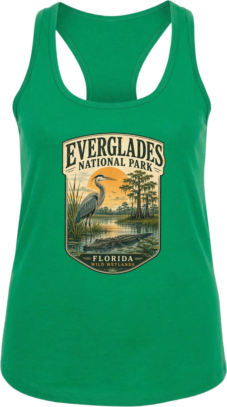 A green tank top with a graphic design depicting a bird, a sunset, and a body of water, along with the text "EVERGLADES NATIONAL PARK FLORIDA WILDER".