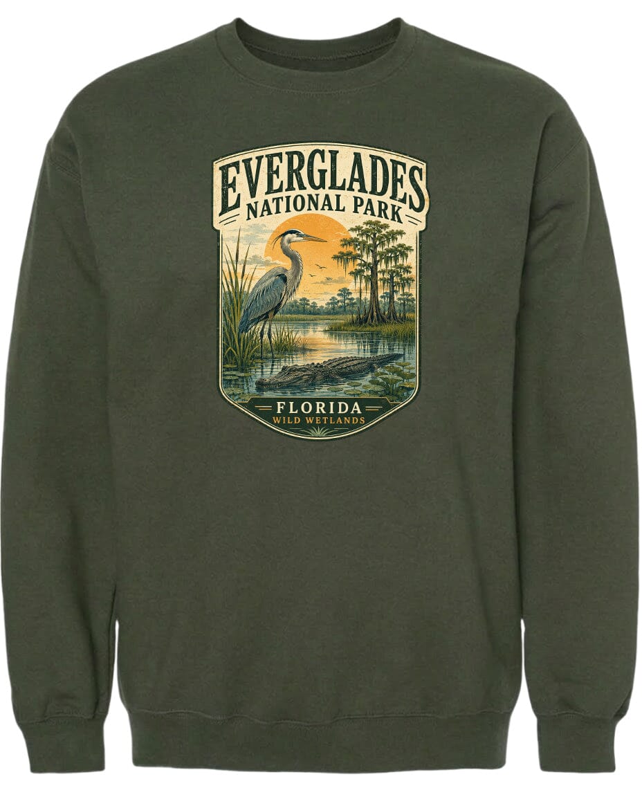 A green sweatshirt with a graphic design depicting a heron and a landscape with trees and water.