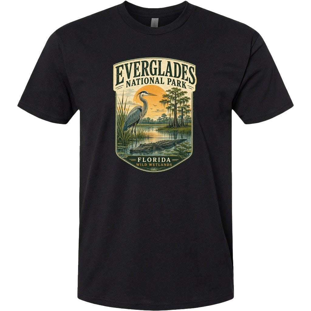 A black t-shirt with a graphic design depicting a bird standing in a marshy area with a bird in the background.