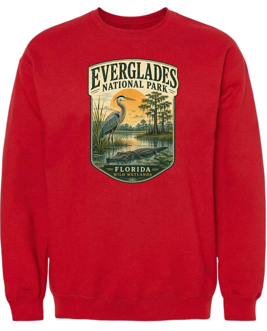 A red sweatshirt with a graphic design depicting Everglades National Park, including a bird, a pond, and trees.