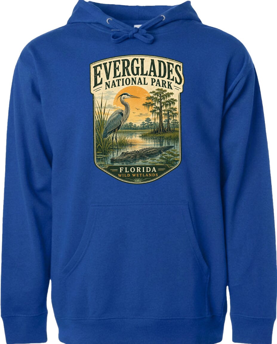 A blue hoodie with a graphic design depicting a heron and a sunset over Everglades National Park, Florida.