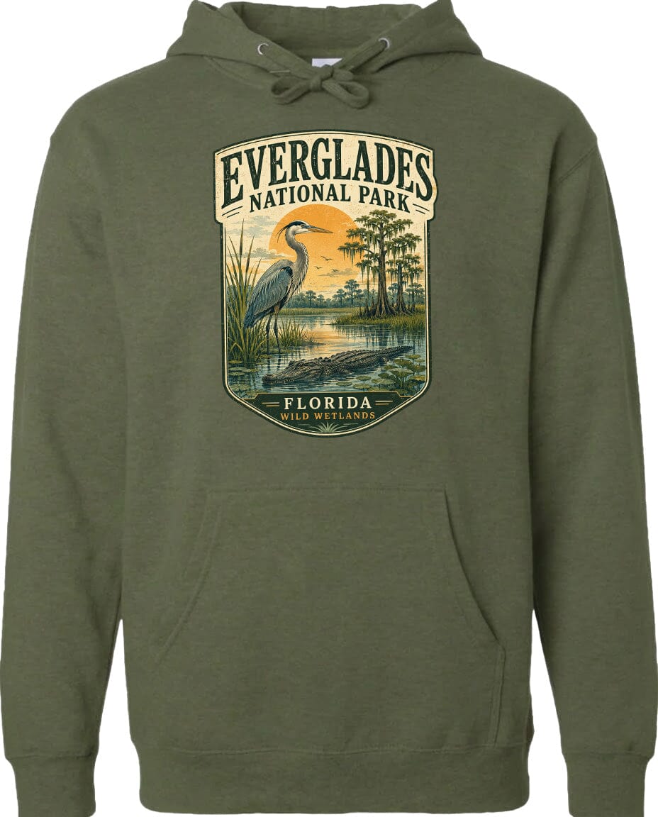 A green hoodie with a graphic design depicting a heron and a sunset over Everglades National Park, Florida.