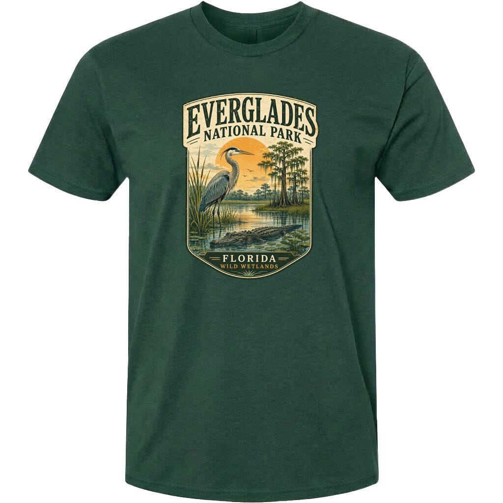 A green t-shirt with a graphic design depicting a bird, a water body, and a landscape with trees and a body of water.