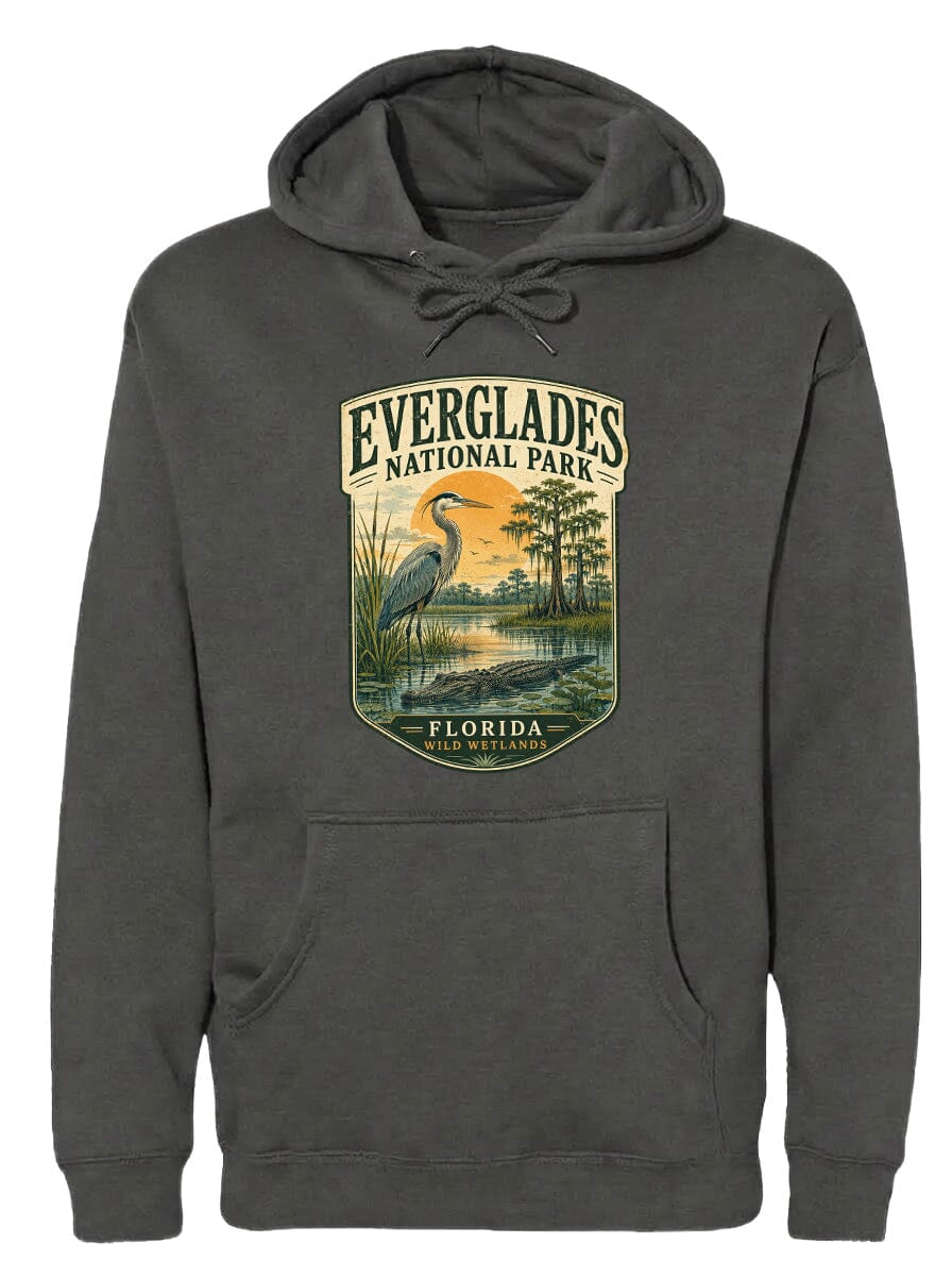 A gray hoodie with a graphic design depicting a bird standing in a pond surrounded by trees and a sunset.