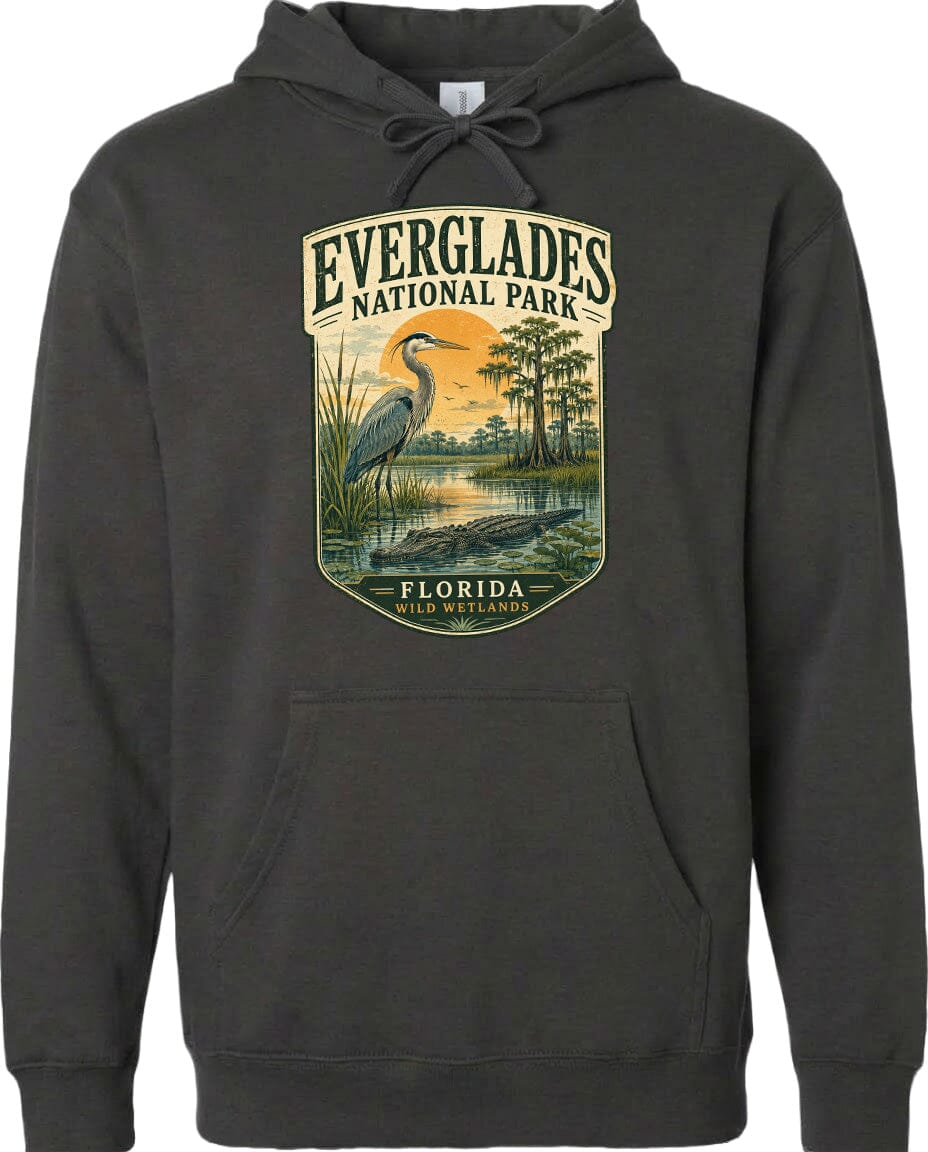 A hoodie with a graphic design depicting Everglades National Park, featuring a large bird, a swampy landscape, and a sunset.