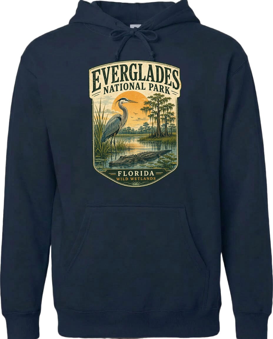 A hoodie with a graphic design depicting a bird standing in a marshy area with trees and a sunset in the background.