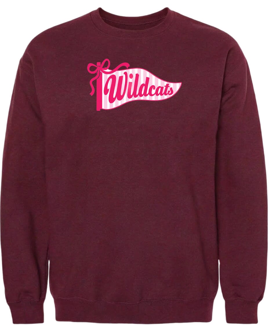 A burgundy sweatshirt with a pink and white banner design featuring the word "Wildcats" on it.